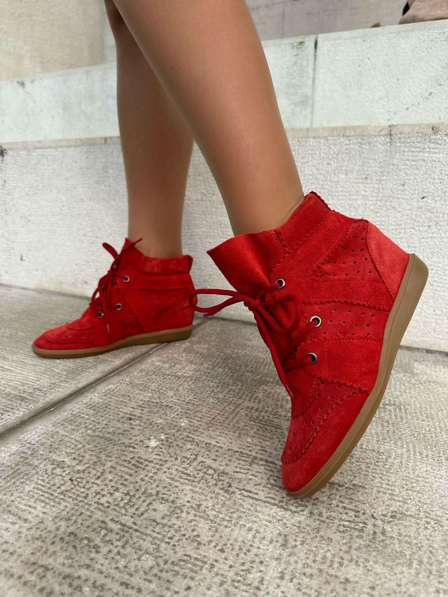 Red sneakers made of genuine leather