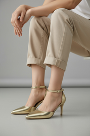 Gold heels on a thin heel