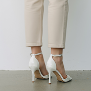 White sandals with a thin heel